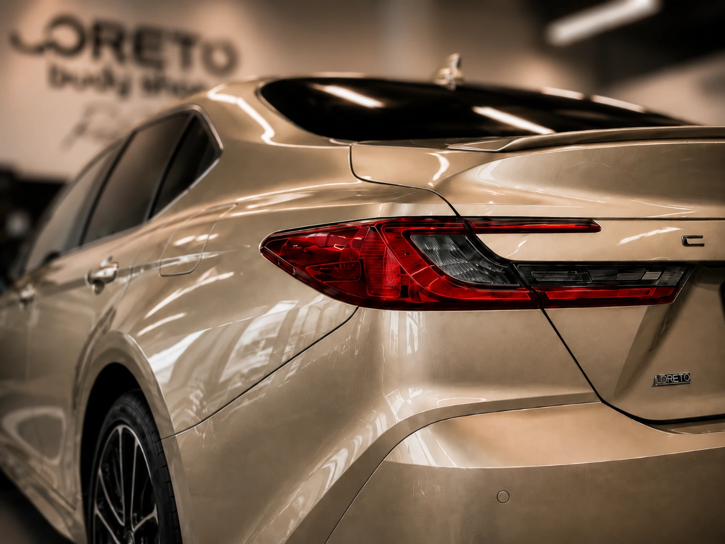 Close-up of a champagne Toyota Camry showing the gloss and reflections of the paint finish
